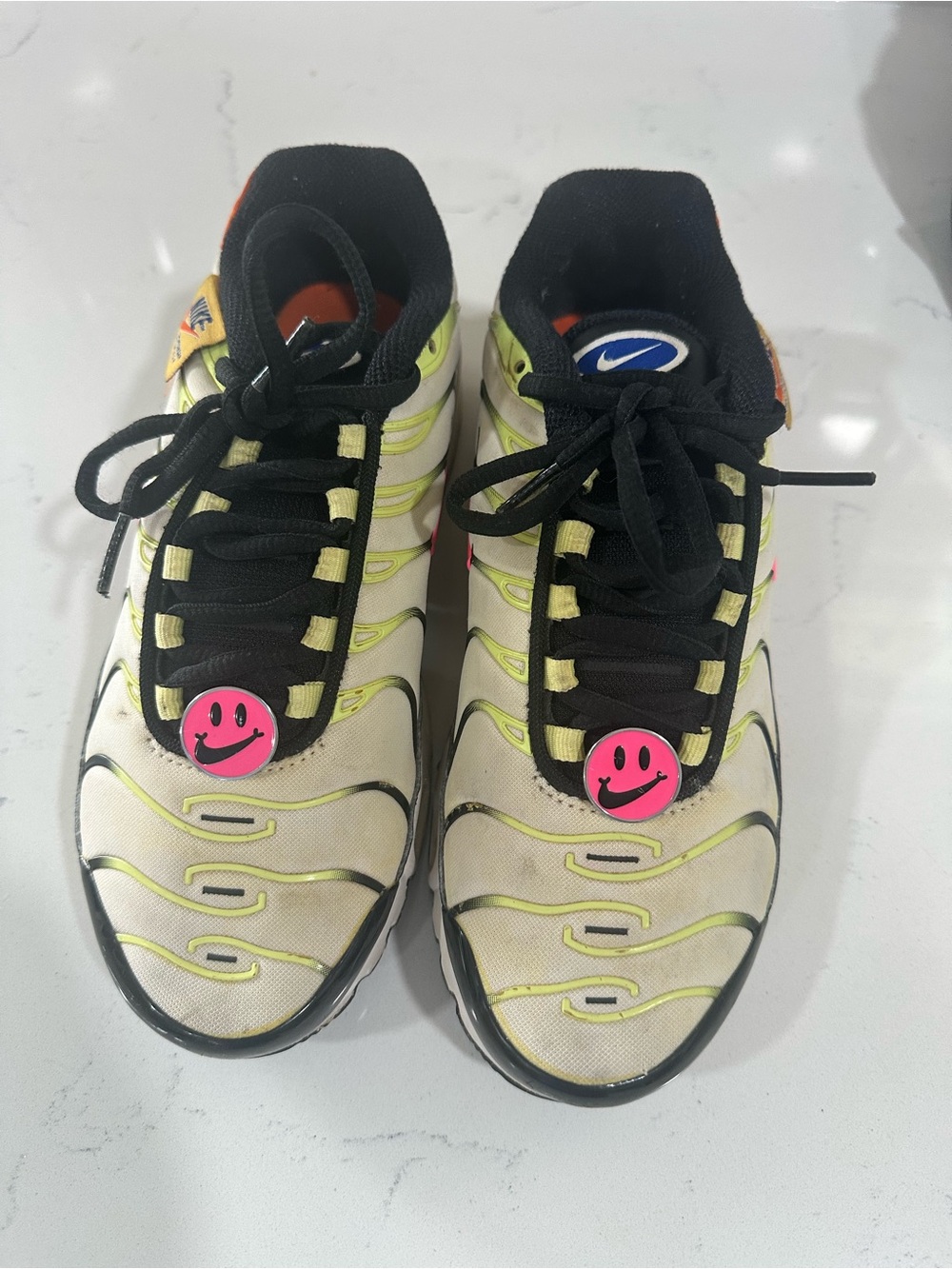 Nike Kids White Sneakers with Neon Yellow Accents and Pink Smiley Charms